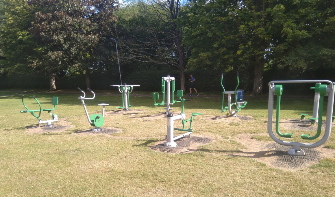 People exercising and playing sport on a park field